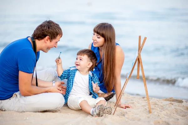 Woman, man and child  on the beach — Stock Photo, Image