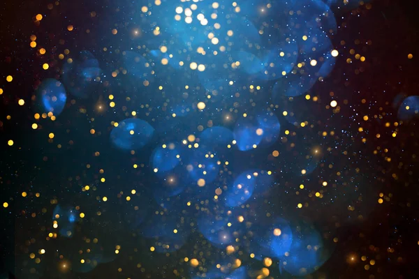 Golden abstract bokeh on dark blue background. — Stock Photo, Image