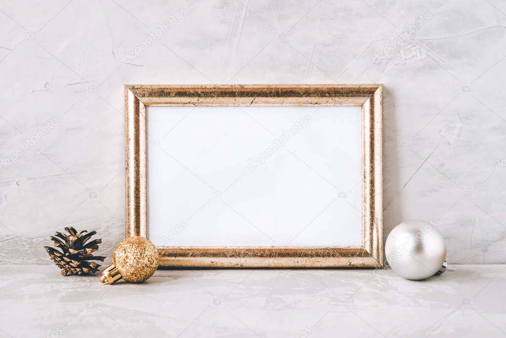 Golden photo frame and christmas decorations.