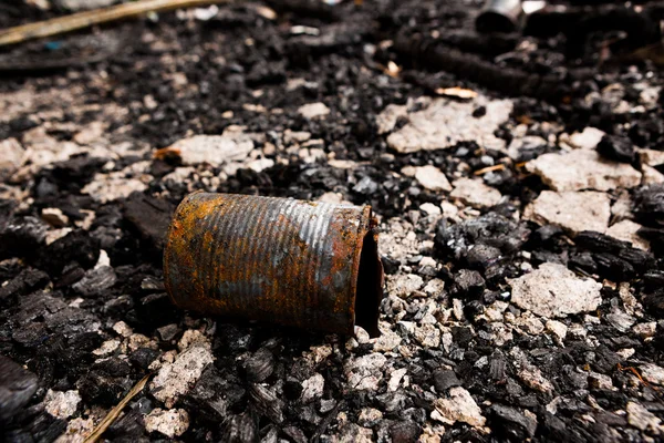 Tin can on burned ground