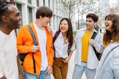 Lise kampüsünde gülen ve takılan bir grup çok ırklı genç öğrenci. Gençlik ve eğitim yaşam tarzı kavramı
