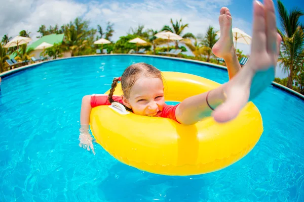 Portrait of happy child with inflatable rubber circle having fun in swimming pool — Stock Photo, Image