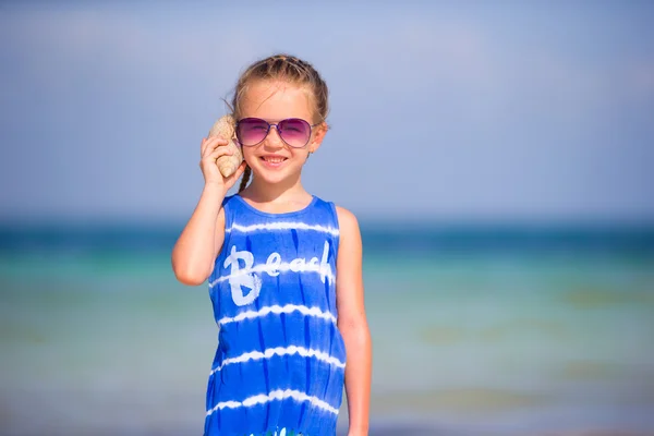 Portrait of adorable little girl with a seashell — Stock Photo, Image