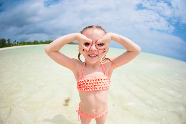 Adorable little girl having fun like as a superhero at beach during summer vacation — Stock Photo, Image