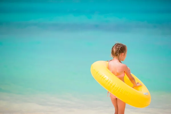 Portrait of little girl with inflatable rubber circle on beach vacation — Stock Photo, Image