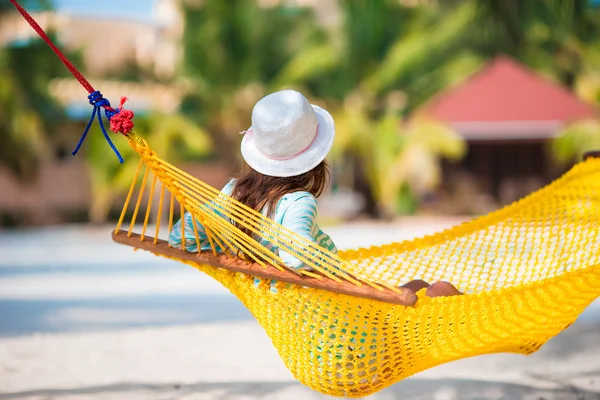 Beautiful girl relaxing at hammock on white beach — Stock Photo, Image