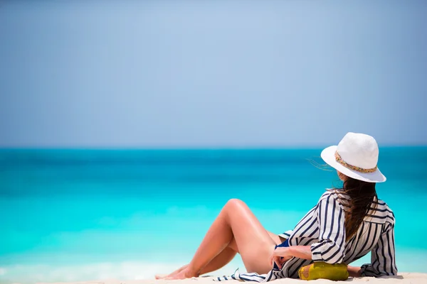 Молодая женщина на белом пляже с кокосом — стоковое фото