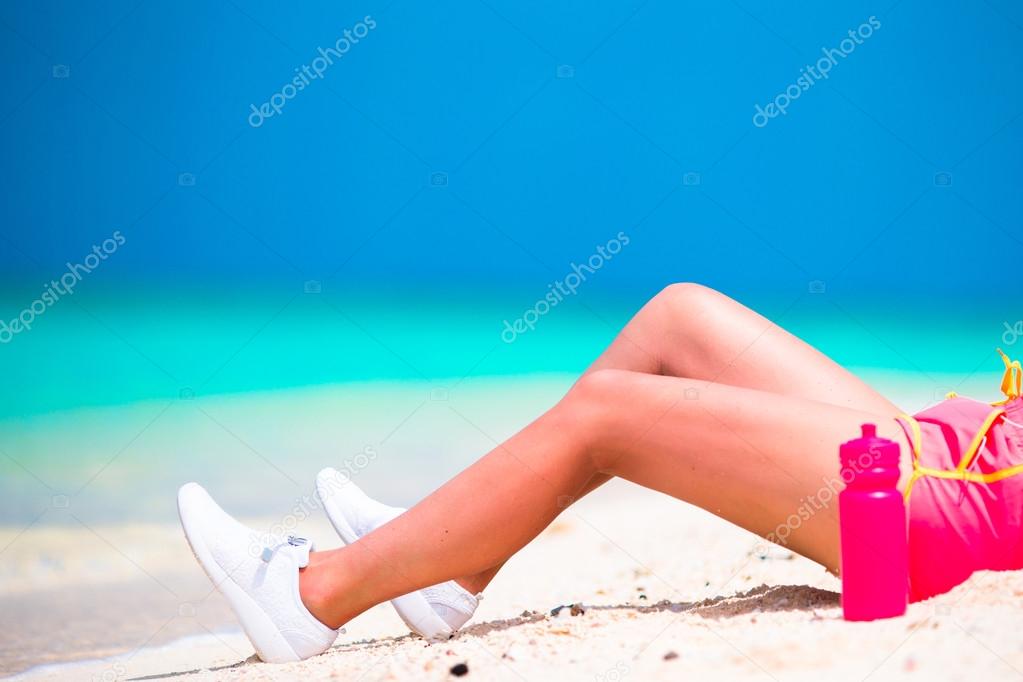 Active fit young woman in her sportswear during beach vacation