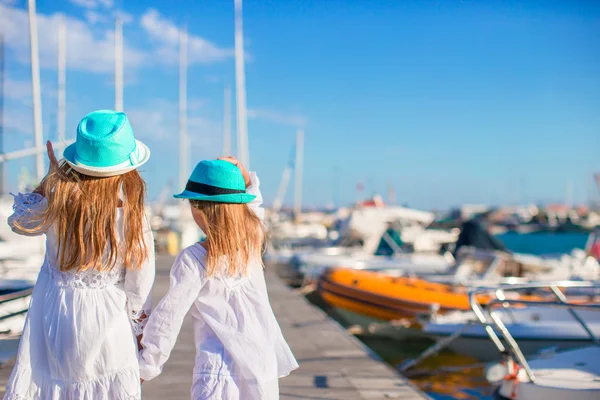 Adorable little girls walking in a port on summer day — Stock Photo, Image