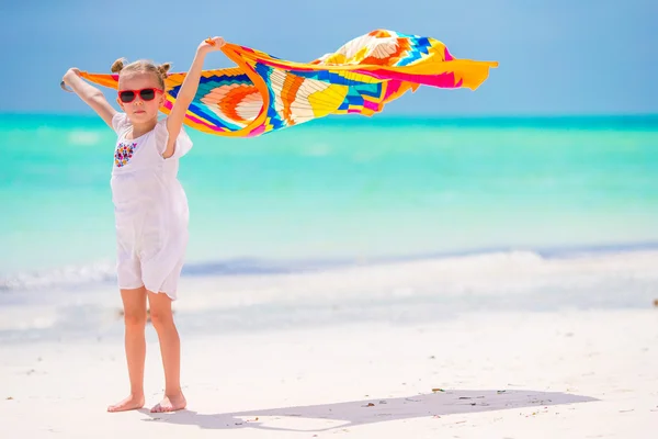 Little girl having fun running with pareo on tropical beach — Stock Photo, Image