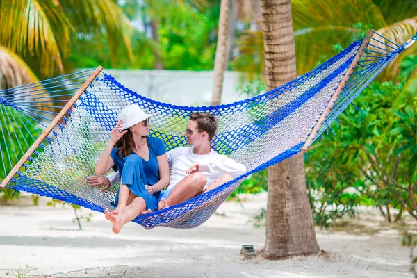 Family on summer vacation relaxing in hammock Stock Photo