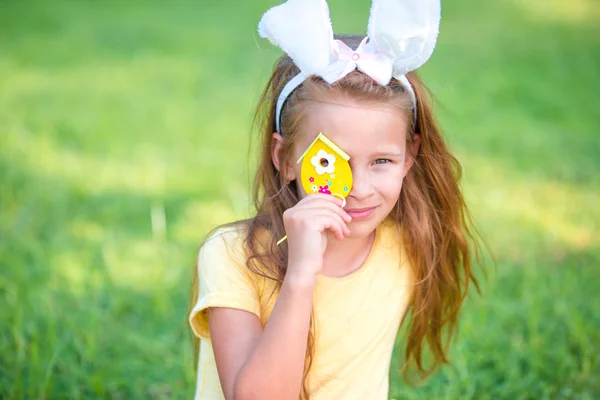 Adorable little girl wearing bunny ears play with Easter eggs — Stock Photo, Image