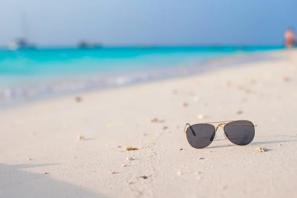 Närbild av solglasögon på tropical beach — Stockfoto