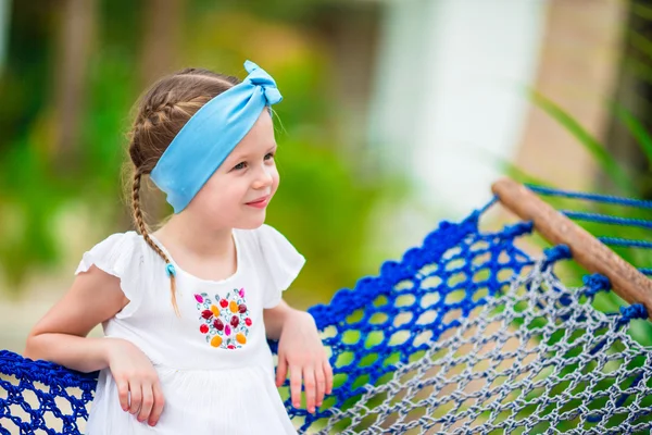 Adorable little girl in hammock outdoor at the beach — Stock Photo, Image