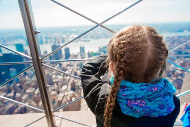 Little girl enjoy view to New York City from Empire State Building clipart