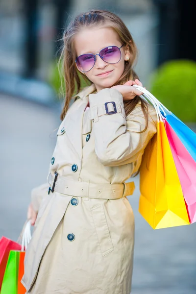 Little fashion girl on shopping outdoors — Stock Photo, Image