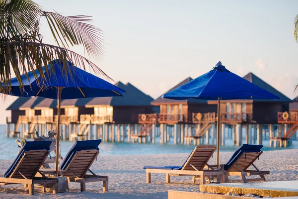Solstolar och parasoller på vackra tropiska resort — Stockfoto