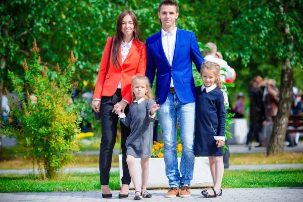 Parents brings theiir little cute daughters to school. Adorable little girls feeling very excited about going back to school — Stock Photo, Image