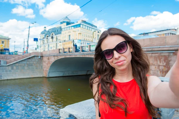 Young caucasian woman making selfie on attractions background outdoors — Stock Photo, Image