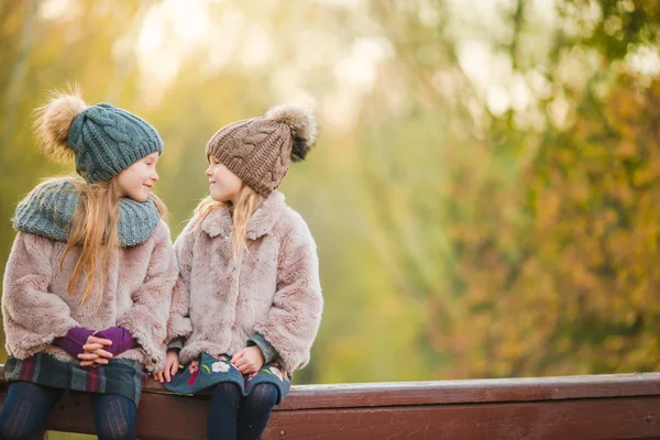 Little adorable girls at warm sunny autumn day outdoors — Stock Photo, Image