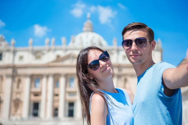 Gelukkige paar toeristen nemen selfie achtergrond St. Peters Basilica kerk in Vaticaanstad, Rome, Italië. De Sint-Pietersbasiliek kerk in Vaticaanstad is de belangrijkste toeristische attracties van Rome. — Stockfoto