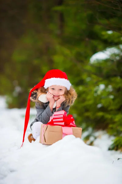 Adorable niña con regalo de caja de Navidad en invierno al aire libre en Nochebuena —  Fotos de Stock