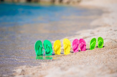 Plajda denizin önünde aile flip flop