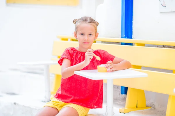 Adorável menina comendo sorvete ao ar livre. Miúdo bonito desfrutando de gelato na Grécia — Fotografia de Stock