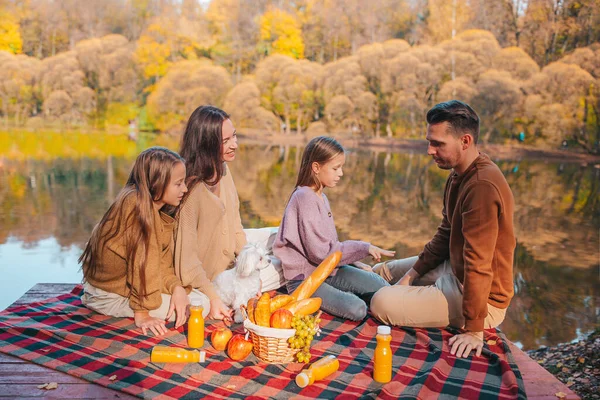 Happy family on a picnic in the park at autumn — Stock Photo, Image