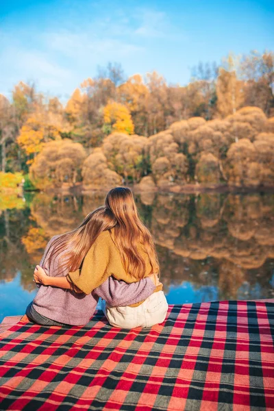 Beautiful girls at autumn warm day near lake — Stock Photo, Image