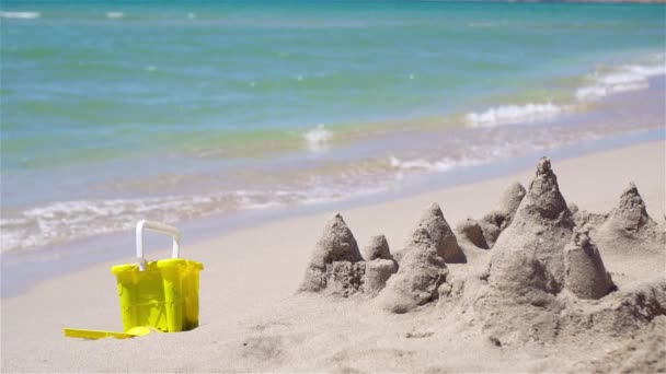 Castillo de arena en la playa tropical blanca con juguetes de plástico para niños — Vídeos de Stock