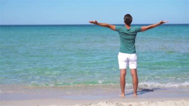 Beyaz sahildeki genç adam tatilde.