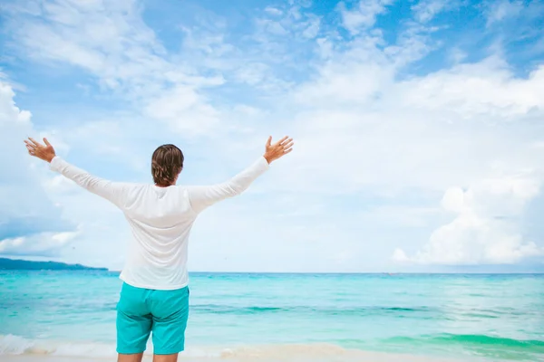 Young man on the white beach on vacation — Stock Photo, Image