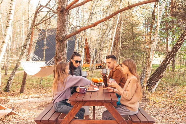 Happy family on a picnic in the park at autumn — Stock Photo, Image