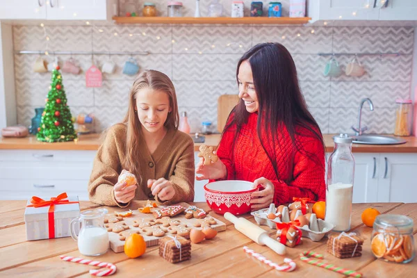 Happy family mother and daughter bake cookies for Christmas — Stock Photo, Image