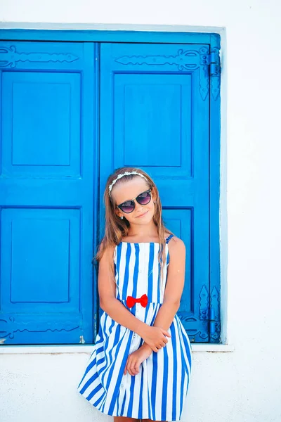 Adorable little girl at old street of typical greek traditional village — Stock Photo, Image