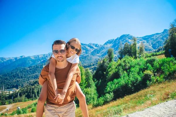 Beautiful happy family in mountains in the background of fog — Stock Photo, Image