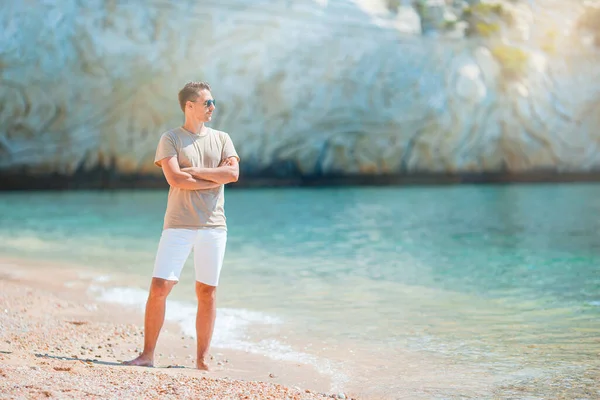 Ung man på stranden har roligt — Stockfoto