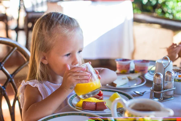 Adorable niña desayunando y bebiendo cóctel de frutas —  Fotos de Stock