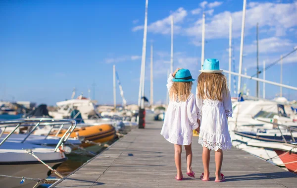 Adorable little girls walking in a port on summer day — Stock Photo, Image