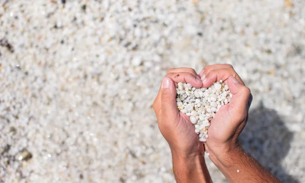Hands in the form of heart with pebbles inside — Stock Photo, Image