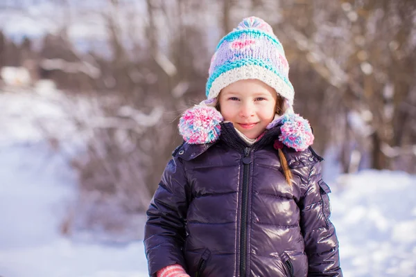 Portrait of little adorable girl in winter hat at snowy forest — Stock Photo, Image