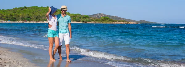 Hermosa pareja joven caminando en la playa durante las vacaciones tropicales —  Fotos de Stock