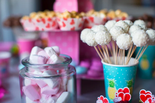 Marshmallow, sweet colored meringues, popcorn, custard cakes and cake pops on table — Stock Photo, Image