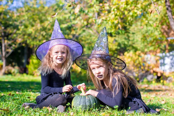 Adorable little girls in witch costume casting a spell on Halloween — Stock Photo, Image