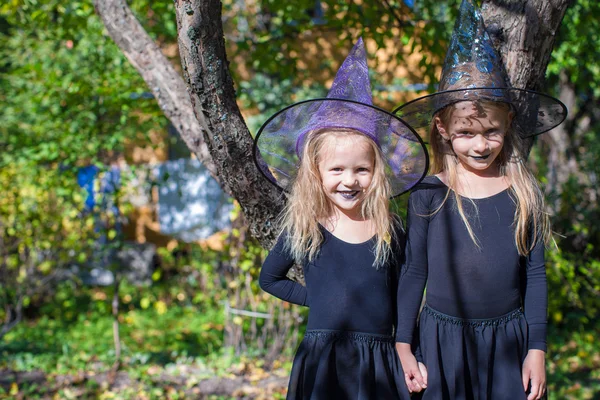 Adorable little girls in witch costume on Halloween outdoors — Stock Photo, Image