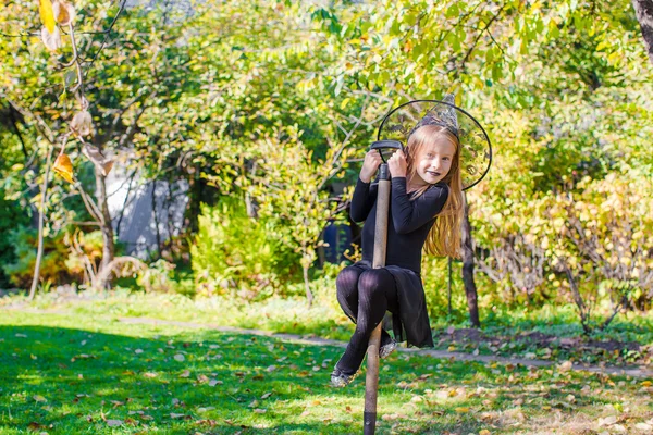 Adorable little girl in Halloween which costume having fun outdoors — Stock Photo, Image