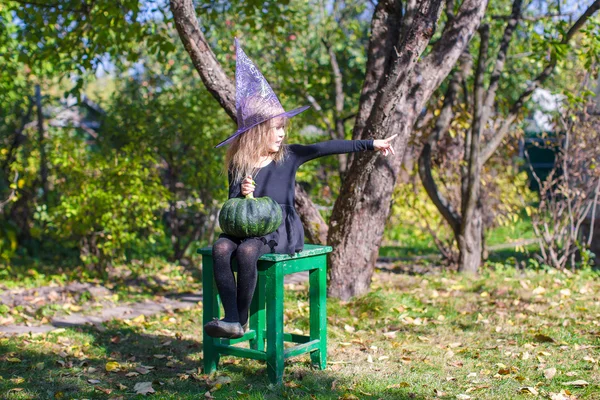 Adorable little girl in Halloween which costume have fun outdoor — Stock Photo, Image