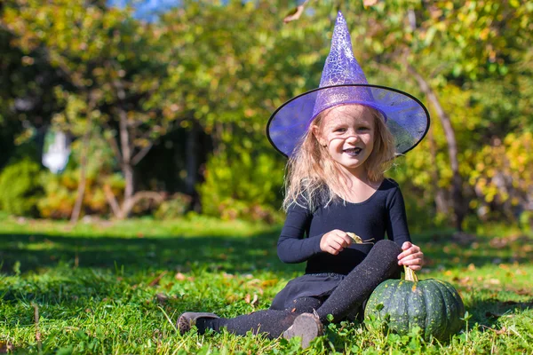 Cute little girl in Halloween which costume have fun outdoor — Stock Photo, Image