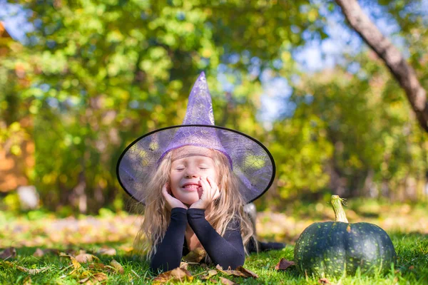 Cute little girl in Halloween costume with jack pumpkin — Stock Photo, Image